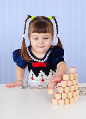 Image showing Little girl playing with toys on table