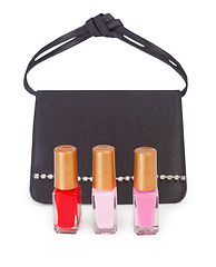 Image showing Small handbag and vials of nail polish