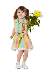 Image showing Happy little girl with a bouquet of flowers