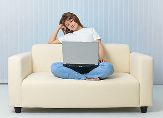 Image showing Tired after work woman reads with laptop