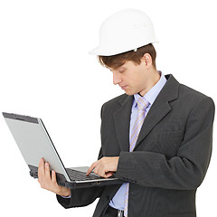Image showing Builder works with laptop holding it on hands