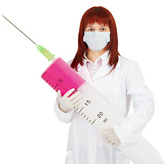 Image showing Young woman doctor with big syringe in hands