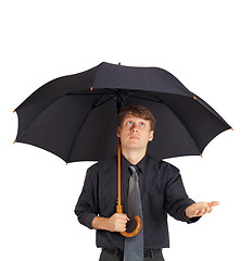 Image showing Young man with large black umbrella