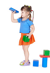 Image showing Little girl playing with toys isolated on white