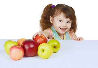 Image showing Little cheerful girl with apples