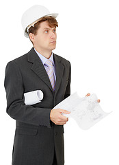 Image showing Serious engineer in helmet with documentation in hands