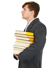 Image showing Young man has stack of library books