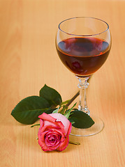 Image showing Glass of red wine and rose