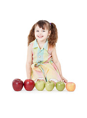 Image showing Happy girl playing with apples on white background