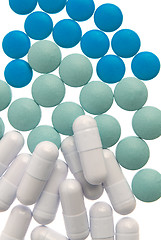 Image showing White capsule, green and blue pills