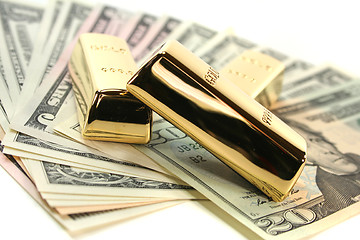 Image showing Gold bullion on dollar bills