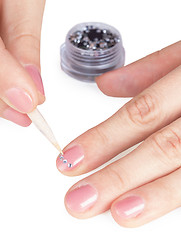 Image showing Process of gluing small paste on nail