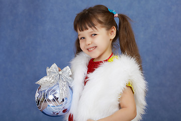 Image showing Little girl in white fur costume holding glass ball