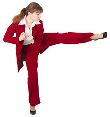 Image showing Young girl kicks, on white background