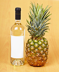 Image showing Bottle of white wine and large pineapple