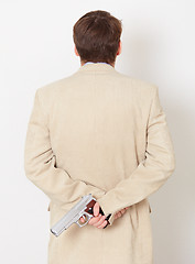 Image showing Person hides behind back weapon - rear view