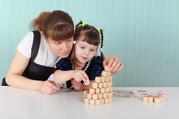 Image showing Mother and daughter playing with toys at table