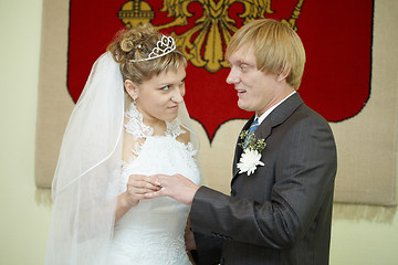 Image showing Young bride solemnly ringed groom