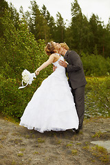 Image showing Groom passionately kisses bride