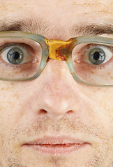 Image showing Face in bad old glasses close-up