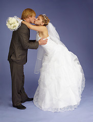 Image showing Bride and groom funny kiss