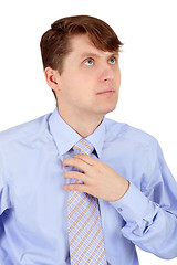 Image showing Man adjusts blue tie isolated on white