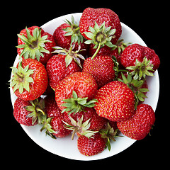 Image showing Strawberries on plate on black background