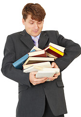 Image showing Man - student hold heap of books and textbooks