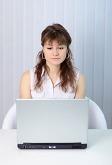 Image showing Young woman working with laptop computer at table