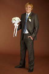 Image showing Happy groom with bouquet