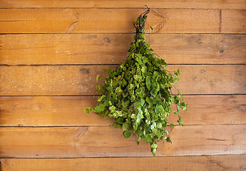 Image showing Birch broom hangs in a bath