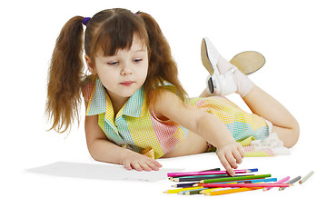 Image showing Little girl draws with crayons