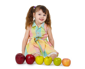 Image showing Little girl and train of apples