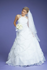 Image showing Beautiful bride poses on violet background