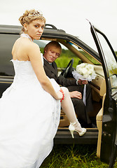 Image showing Sexual bride and groom in car