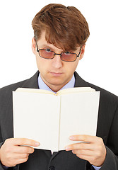 Image showing Serious man gets acquainted with contents of book