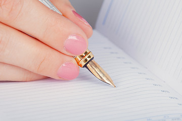 Image showing Golden pen and notebook