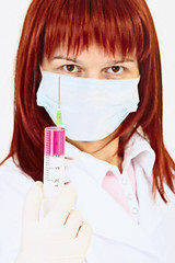 Image showing Young woman doctor with syringe in hand