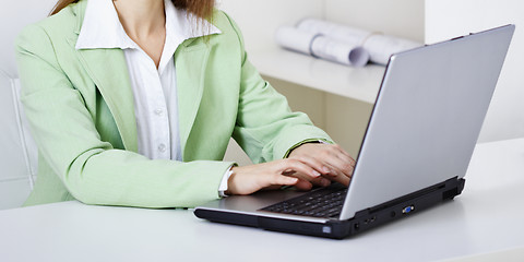 Image showing Woman works with computer on workplace at office