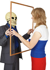 Image showing Woman looks at skeleton as reflected