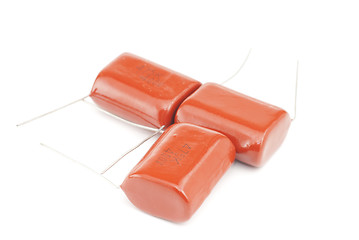 Image showing Three orange  capacitor  isolated on white background