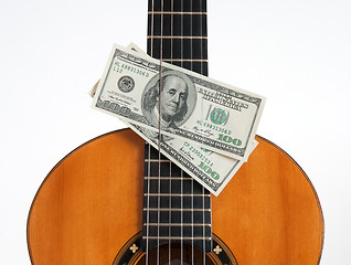 Image showing Classical guitar and money