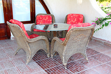 Image showing wicker chair and table outdoors