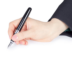 Image showing Female hand holds pen