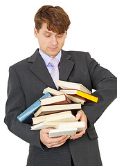 Image showing Student bears big pile of textbooks in hands