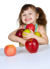 Image showing Happy little girl with apples