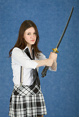 Image showing Girl - teenager menacingly brandishes a sword