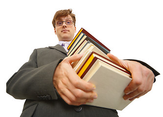 Image showing Young man with pile of books in hands