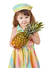 Image showing Sad little girl holding large pineapple