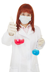 Image showing Female scientist offers red bulb